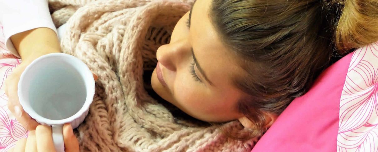 woman in bed with lemsip representing self-help & self-care